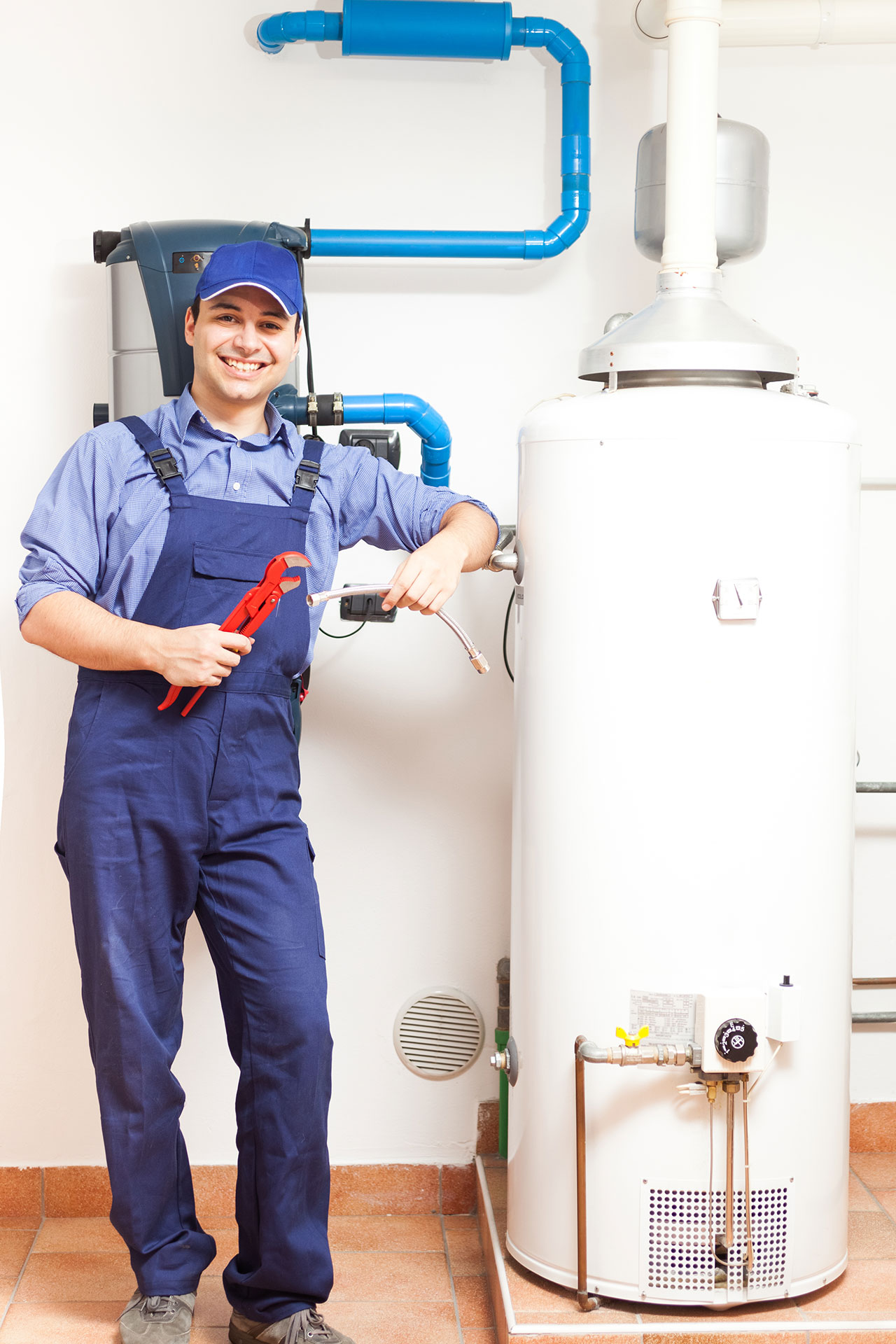 a plumber standing next to a water heater